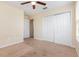 This bedroom offers carpet flooring with closet and natural light from a window with a ceiling fan at 2347 Richwood Pike Dr, Ruskin, FL 33570