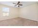 This bedroom features neutral walls, carpet flooring, and a ceiling fan for a comfortable living space at 2347 Richwood Pike Dr, Ruskin, FL 33570