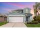 Charming two-story home with attached two car garage and well-manicured lawn at 2347 Richwood Pike Dr, Ruskin, FL 33570