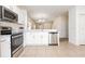 Updated kitchen with stainless steel appliances, white cabinets, granite counters, and tile flooring at 2347 Richwood Pike Dr, Ruskin, FL 33570