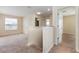 Second floor landing with neutral carpet and access to multiple rooms at 2347 Richwood Pike Dr, Ruskin, FL 33570