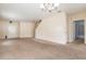Spacious living room featuring neutral carpet, staircase, and an open layout to the front door and dining area at 2347 Richwood Pike Dr, Ruskin, FL 33570
