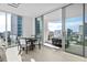 Bright condo dining area with city views, access to balcony, and seating for four at 301 Quay Commons # 1106, Sarasota, FL 34236