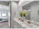 Spacious bathroom featuring double sinks, marble countertops, and neutral tones at 3747 Laughing Dove Ave, Sun City Center, FL 33573