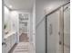 Bathroom with double sinks, a glass shower, and a walk-in closet at 3747 Laughing Dove Ave, Sun City Center, FL 33573
