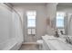 Bathroom featuring a tub, shower with white tile, marble countertop, and white cabinets at 3747 Laughing Dove Ave, Sun City Center, FL 33573