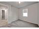 Comfortable bedroom with plush carpeting, a window, a ceiling fan and a doorway at 3747 Laughing Dove Ave, Sun City Center, FL 33573