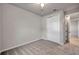 Bright bedroom with neutral walls, plush carpeting, closet, and doorway at 3747 Laughing Dove Ave, Sun City Center, FL 33573