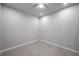 Empty bedroom with gray tile flooring, white trim, and fresh paint at 3747 Laughing Dove Ave, Sun City Center, FL 33573