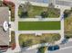 Aerial view of community common area with manicured landscaping, benches, and a walkway leading to the clubhouse at 3747 Laughing Dove Ave, Sun City Center, FL 33573