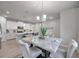 Dining area featuring a modern marble table, stylish chairs, and views into the adjacent kitchen at 3747 Laughing Dove Ave, Sun City Center, FL 33573