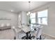 Light-filled dining area boasting a modern marble table, seating for four, and a serene ambiance at 3747 Laughing Dove Ave, Sun City Center, FL 33573