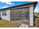 Side view of the home exterior with a screened-in patio at 3747 Laughing Dove Ave, Sun City Center, FL 33573