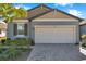 Charming single Gathering home featuring a two-car garage and beautifully landscaped front yard at 3747 Laughing Dove Ave, Sun City Center, FL 33573