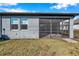Rear view of the home featuring a screened lanai at 3747 Laughing Dove Ave, Sun City Center, FL 33573