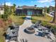 A community fire pit area surrounded by Adirondack chairs, situated near a pickleball court and landscaped grounds at 3747 Laughing Dove Ave, Sun City Center, FL 33573