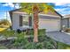 Charming home featuring a well-manicured front yard and an attached two-car garage at 3747 Laughing Dove Ave, Sun City Center, FL 33573