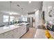Open floor plan displays the modern kitchen with stainless steel appliances and a spacious island at 3747 Laughing Dove Ave, Sun City Center, FL 33573