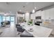 Open kitchen featuring a spacious island with barstool seating and stainless steel appliances at 3747 Laughing Dove Ave, Sun City Center, FL 33573