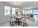Open-concept kitchen, living and dining area filled with natural light at 3747 Laughing Dove Ave, Sun City Center, FL 33573
