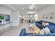 Bright living room featuring tile floors, modern furniture, and a ceiling fan at 3747 Laughing Dove Ave, Sun City Center, FL 33573