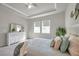 Beautifully decorated main bedroom boasts large windows, tray ceiling, and neutral carpet at 3747 Laughing Dove Ave, Sun City Center, FL 33573