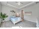 Elegant main bedroom featuring a tray ceiling, decorative furnishings, and neutral tones at 3747 Laughing Dove Ave, Sun City Center, FL 33573