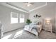 Stylishly furnished main bedroom with decorative headboard, tray ceiling, and neutral carpet at 3747 Laughing Dove Ave, Sun City Center, FL 33573