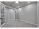 Bright office space with neutral walls, gray tiled floors and glass paneled French doors at 3747 Laughing Dove Ave, Sun City Center, FL 33573
