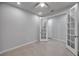 Bright office space with neutral walls, and light tiled floors featuring glass paneled French doors at 3747 Laughing Dove Ave, Sun City Center, FL 33573