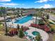A community pool and hot tub area, with palm trees, cabanas, and a variety of seating for relaxation and socializing at 3747 Laughing Dove Ave, Sun City Center, FL 33573