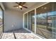 Spacious screened patio with brick flooring and a ceiling fan at 3747 Laughing Dove Ave, Sun City Center, FL 33573