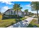 A street view showcasing multiple single-Gathering homes, each featuring similar landscaping at 3747 Laughing Dove Ave, Sun City Center, FL 33573