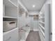 Large walk-in closet with built-in shelving and hanging rods at 3747 Laughing Dove Ave, Sun City Center, FL 33573