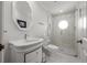 Bathroom featuring mosaic tile floor, glass enclosed shower, and a round picture window at 400 N Washington Dr, Sarasota, FL 34236