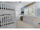 bedroom featuring a bunk bed, blue walls with white wainscoting and trim, and custom painted ceiling decor at 400 N Washington Dr, Sarasota, FL 34236