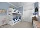 bedroom featuring a bunk bed, blue walls with white wainscoting and white trim, and a built-in closet at 400 N Washington Dr, Sarasota, FL 34236