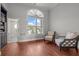 Sitting room featuring hardwood floors, shuttered arched windows, and 2 floral accent chairs at 400 N Washington Dr, Sarasota, FL 34236