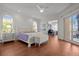 Bright main bedroom featuring hardwood floors, arched windows, ensuite office and sliding glass doors to the outside deck at 400 N Washington Dr, Sarasota, FL 34236