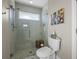 Walk-in shower featuring glass doors, hexagon tiling, and a shower niche with a small window at 400 N Washington Dr, Sarasota, FL 34236