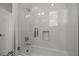 Walk-in shower with glass doors, white subway tile, built-in shower niche, and polished chrome fixtures at 400 N Washington Dr, Sarasota, FL 34236