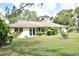 A well-maintained backyard with lush green grass, mature trees, and a serene view at 5244 Marsh Field Rd # 6, Sarasota, FL 34235