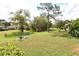 Expansive backyard with lush green grass and mature trees at 5244 Marsh Field Rd # 6, Sarasota, FL 34235