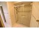 Bathroom featuring a glass-enclosed shower, tiled walls, and a shower head at 5244 Marsh Field Rd # 6, Sarasota, FL 34235