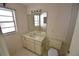 Bathroom with a single sink vanity, a window, and a toilet at 5244 Marsh Field Rd # 6, Sarasota, FL 34235