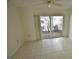 Bright bedroom with tile flooring and sliding door access to the outdoors at 5244 Marsh Field Rd # 6, Sarasota, FL 34235