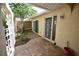 Private courtyard with brick pavers, mature foliage, and access to the home at 5244 Marsh Field Rd # 6, Sarasota, FL 34235