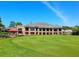 Exterior shot of the golf clubhouse set on a pristine golf course at 5244 Marsh Field Rd # 6, Sarasota, FL 34235