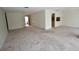Open living room with neutral carpet and access to other parts of the home at 5244 Marsh Field Rd # 6, Sarasota, FL 34235