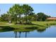 Scenic golf course view featuring lush greenery, tranquil pond, and players enjoying a round of golf at 5247 Esplanade Blvd, Bradenton, FL 34211